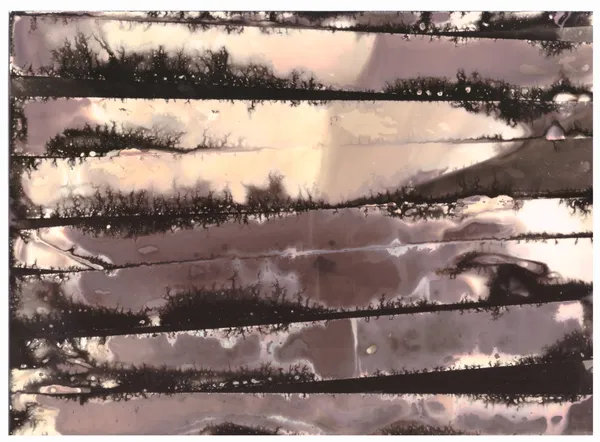 Horizontal dark bands bleeding across a pale surface