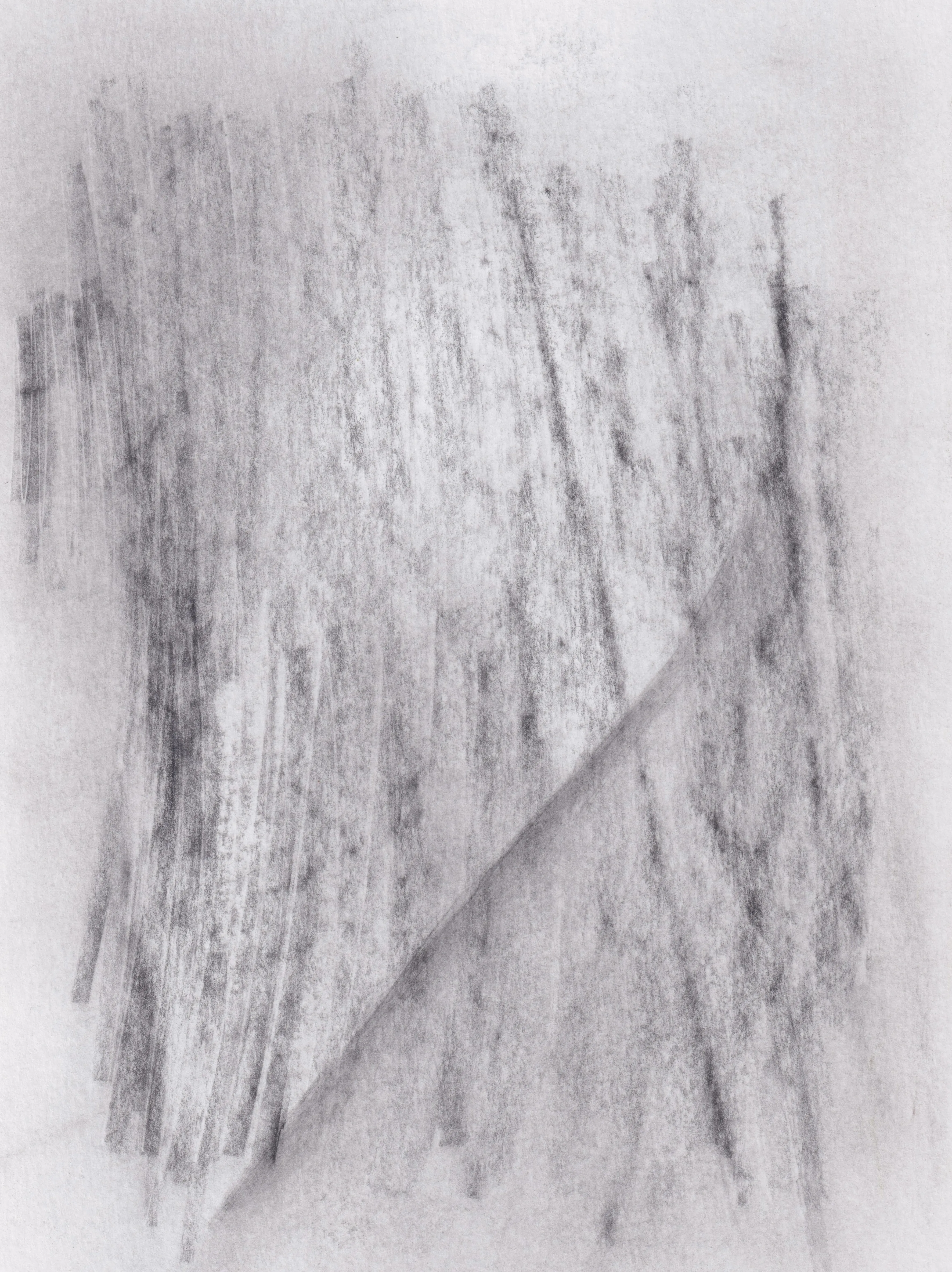 Soft vertical graphite strokes on white paper, cut by a single diagonal crease of tone