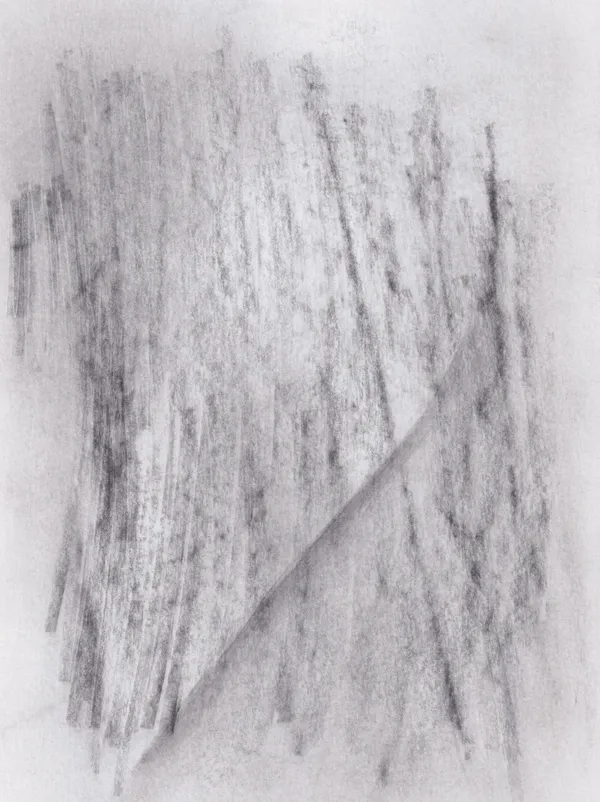 Soft vertical graphite strokes on white paper, cut by a single diagonal crease of tone