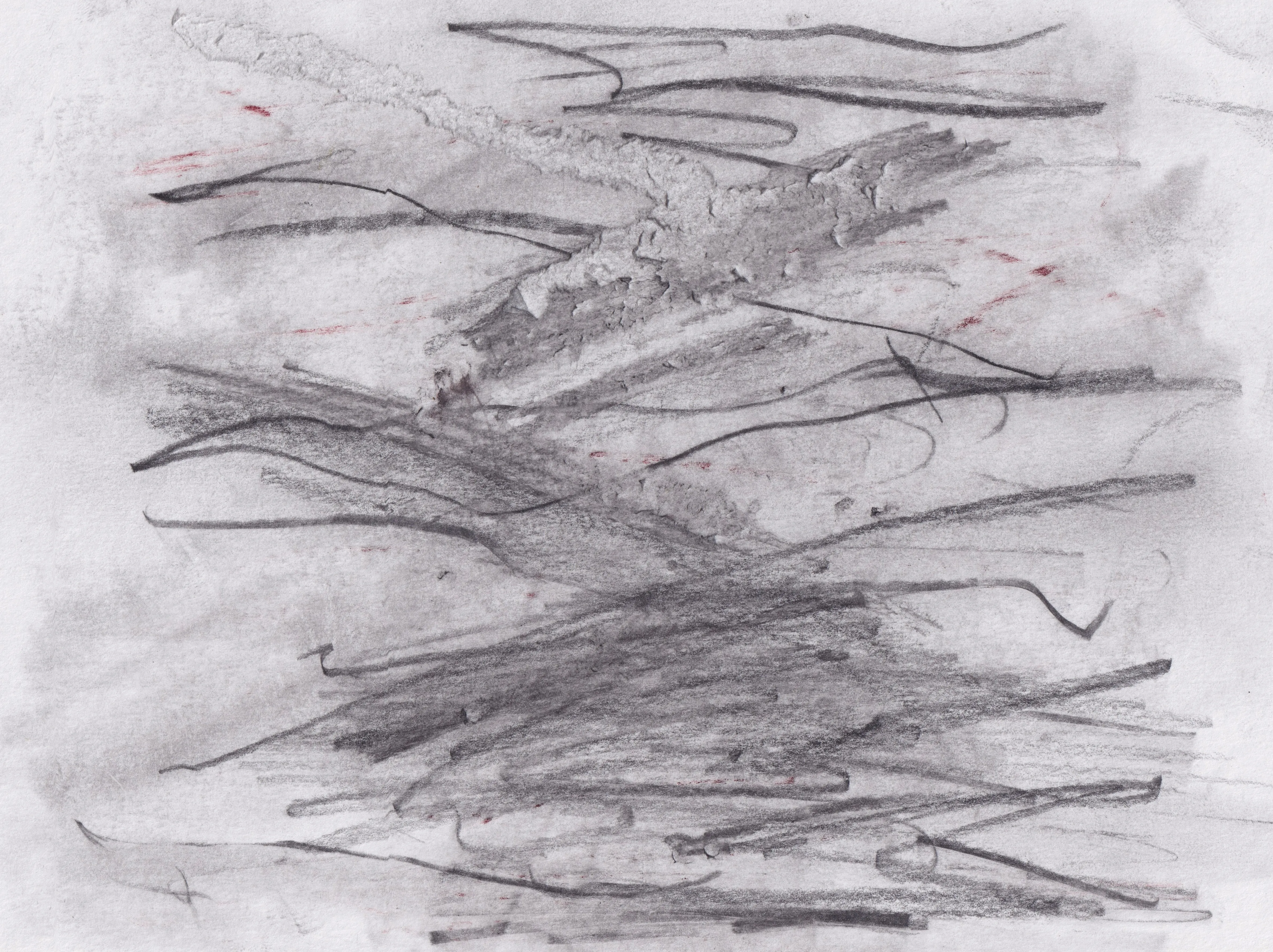 Dense horizontal graphite scribbles over a grey wash on white paper, with a few small red marks