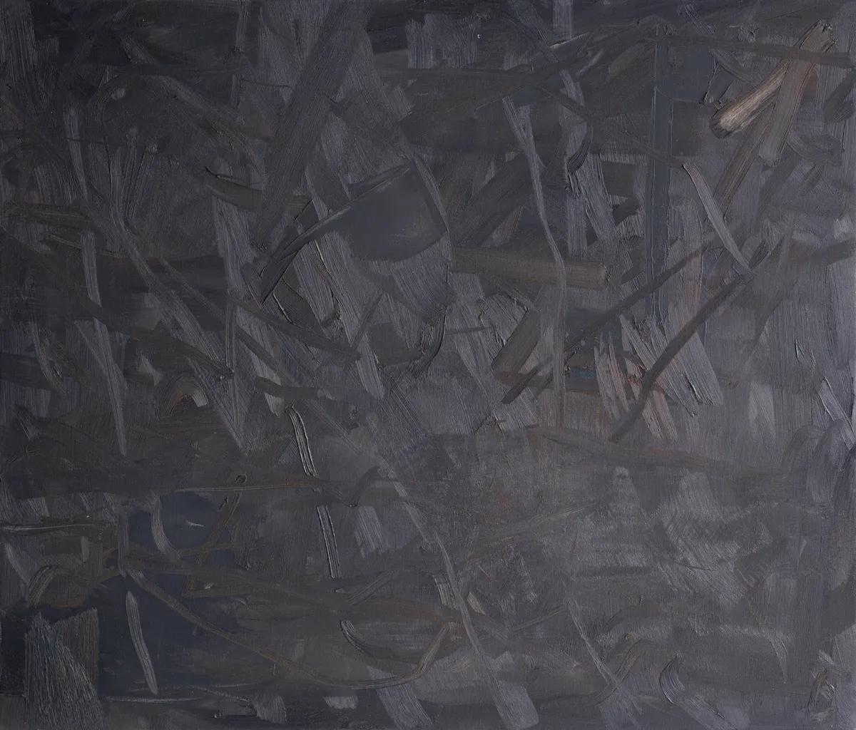 Wide canvas of near-black worked in thick crossing strokes, their ridges catching the light grey, with a single pale fleck at the upper right